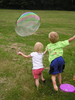 Kids chase a bubble at a famil