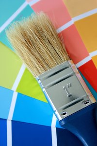Paint Brush: Blue handled paint brush against a colour chart