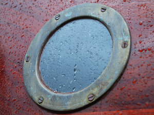 Boat Porthole: Window on an old wooden boat.