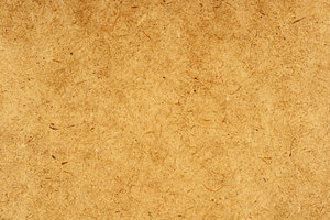Fiber Texture: The close-up texture of a fibrous composition board used as a construction material.