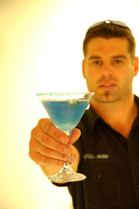 Barman offering: Barman offering a cocktail.NB: Credit to read 