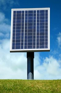 Solar Panel: Solar panel against a blue sky and green grass