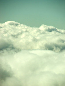 above the clouds - through the: clouds seen through plane window during flight