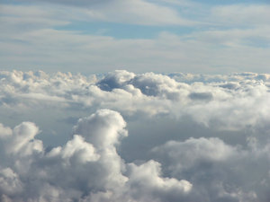 between the clouds: clouds seen through plane window during flight