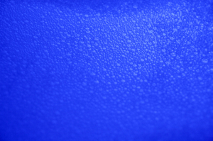 Bubble Texture: A dark blue closeup view of bath bubbles on water, suitable for a background.