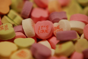 It's Love: Close up of a candy heart displaying the message, 'it's love'.